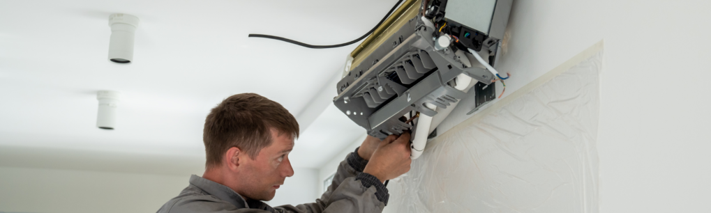man repairing electrical system