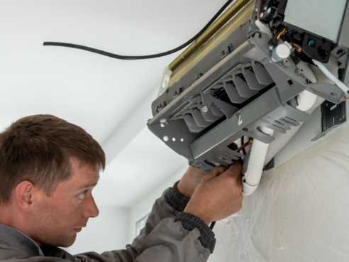 man repairing electrical system